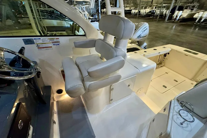 Slide: The Image of Interior of a 2014 Pursuit OS 345 Offshore boat, featuring a comfortable captain's chair. - 3