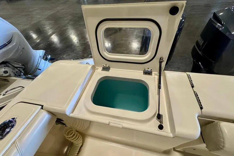 Slide: The Image of Livewell compartment on a 2014 Pursuit OS 345 Offshore boat, showcasing interior details. - 11