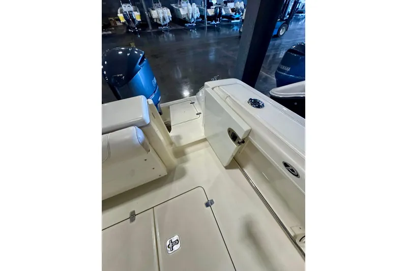 Slide: The Image of 2014 Pursuit OS 345 Offshore boat interior with Yamaha outboard engines in showroom. - 17
