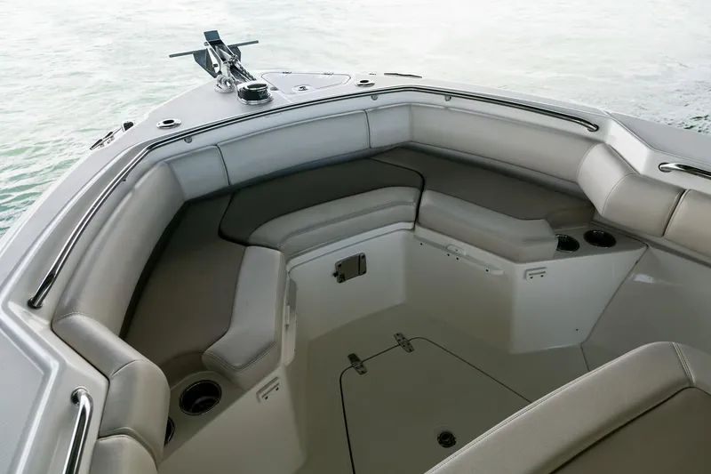 Slide: The Image of Manufacturer Provided Image: 2025 Boston Whaler 250 Outrage boat interior with cushioned seating and cup holders. - 14