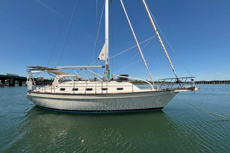 The Image of 2015 Island Packet 370 sailboat on calm water under clear blue sky. - 0