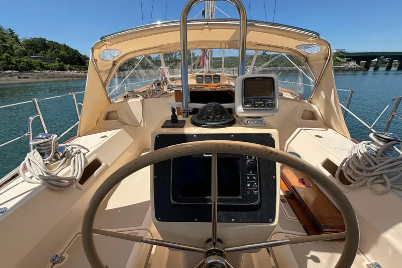 Slide: The Image of Cockpit view of 2015 Island Packet 370 sailboat with navigation equipment and steering wheel. - 10