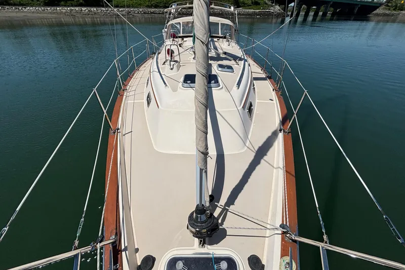 Slide: The Image of 2015 Island Packet 370 sailboat deck view, moored on calm water. - 12