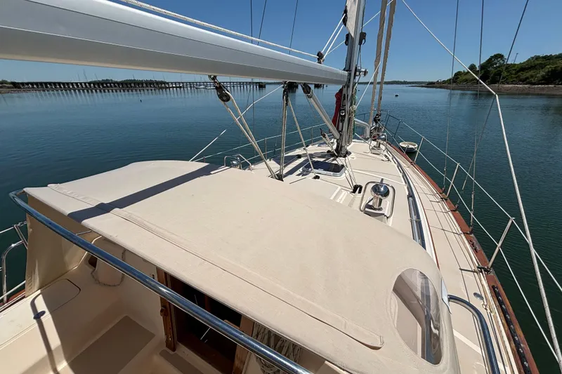 Slide: The Image of 2015 Island Packet 370 sailboat on calm water, showcasing deck and rigging. - 17