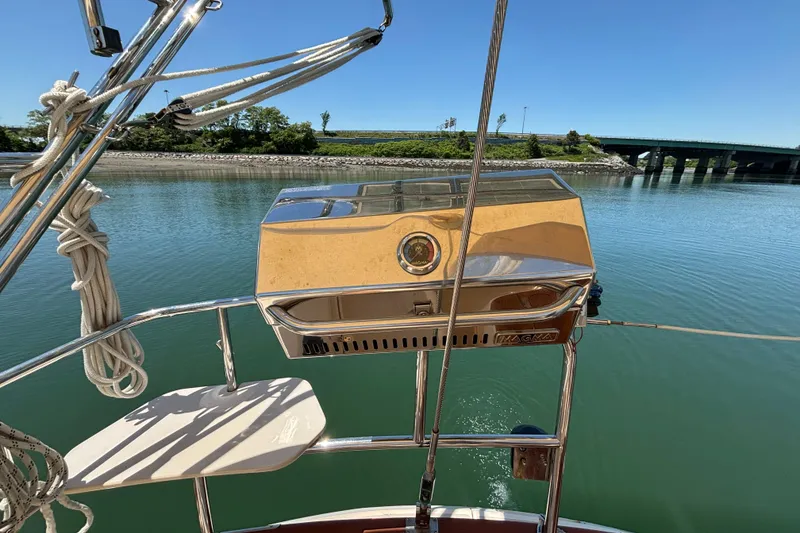 Slide: The Image of Sailboat Island Packet 370 (2015) with a Magma grill on deck, near a bridge. - 20