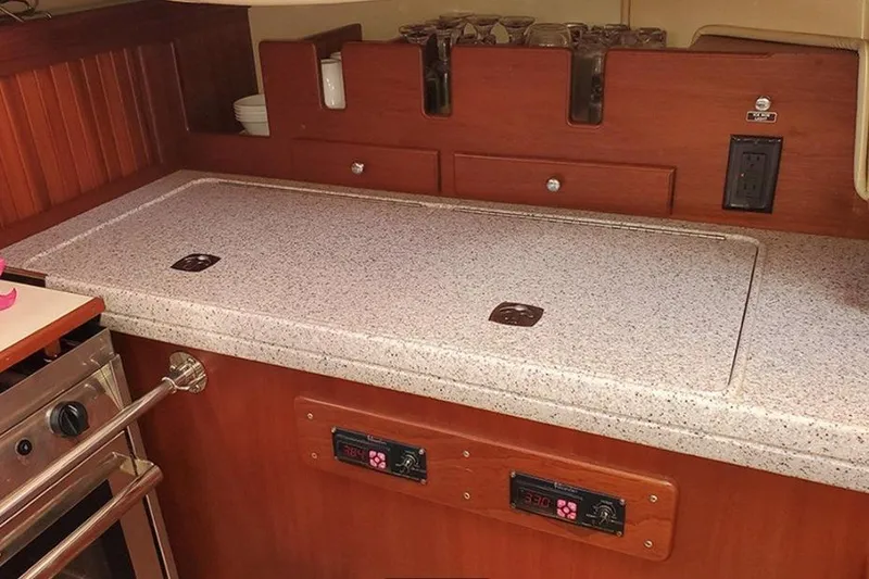 Slide: The Image of Galley kitchen in 2015 Island Packet 370 sailboat with wooden cabinetry and countertop. - 25