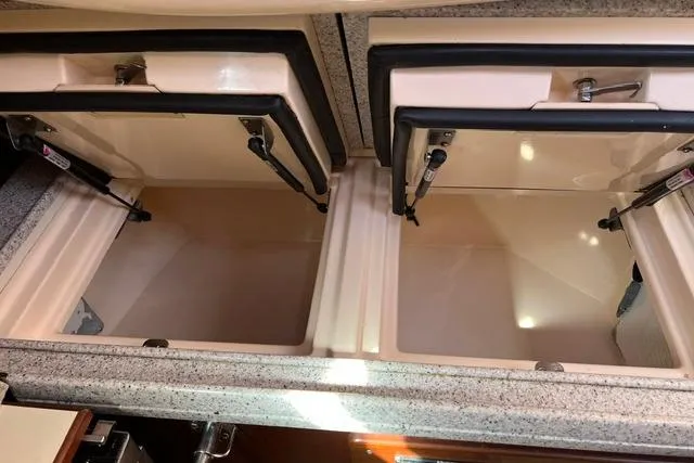 Slide: The Image of Interior storage compartments of a 2015 Island Packet 370 yacht, featuring dual hatches. - 26