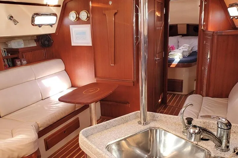 Slide: The Image of Luxurious interior of 2015 Island Packet 370 yacht with cozy seating and elegant wood finish. - 27
