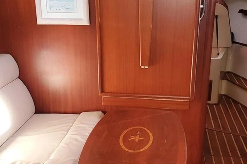 Slide: The Image of Interior of 2015 Island Packet 370 yacht with wooden table and seating area. - 30