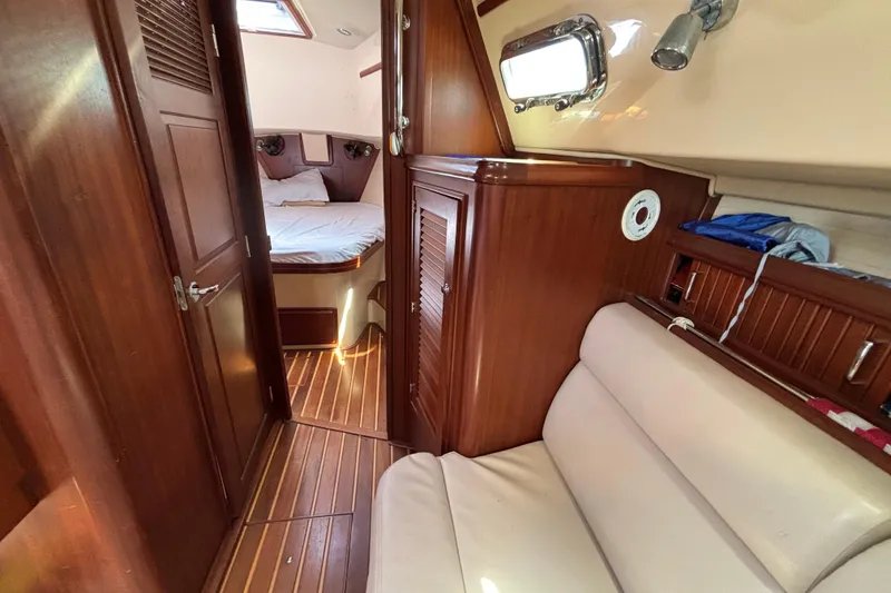 Slide: The Image of Interior of 2015 Island Packet 370 sailboat with wood finish and cozy cabin. - 32