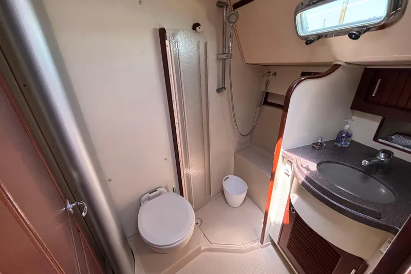 Slide: The Image of 2015 Island Packet 370 yacht bathroom with shower, toilet, and sink. - 34