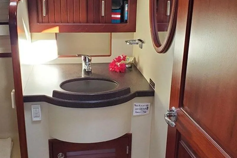 Slide: The Image of Luxurious 2015 Island Packet 370 yacht bathroom with elegant wood cabinetry and modern sink. - 35