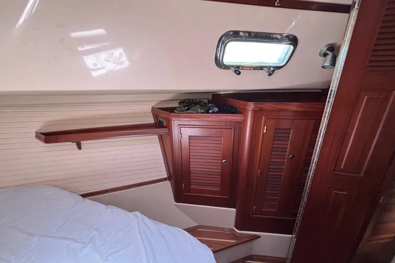 Slide: The Image of Interior cabin of 2015 Island Packet 370 sailboat with wooden cabinetry and porthole window. - 36
