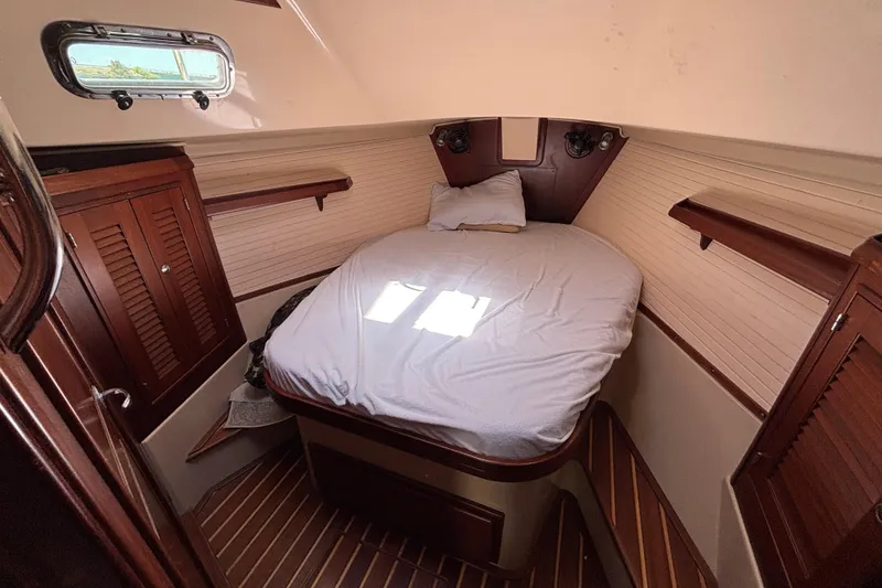 Slide: The Image of Cozy cabin interior of 2015 Island Packet 370 sailboat with wooden accents and a comfortable bed. - 38