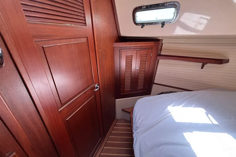 Slide: The Image of Cozy cabin interior of 2015 Island Packet 370 sailboat with wooden cabinetry and bed. - 39