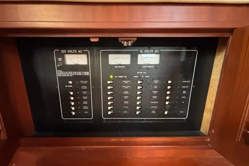 Slide: The Image of Electrical control panel on a 2015 Island Packet 370 sailboat, featuring AC and DC switches. - 40