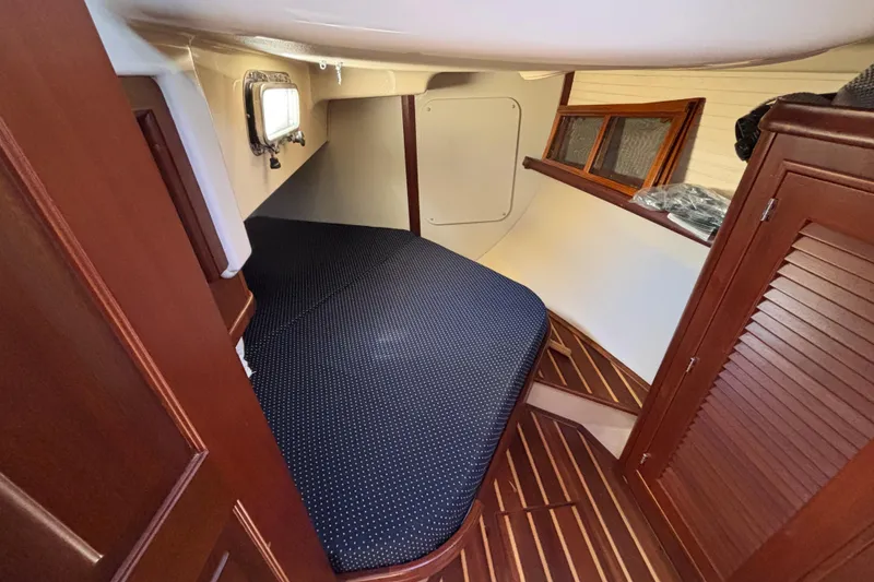 Slide: The Image of Interior cabin of 2015 Island Packet 370 sailboat with wooden finishes and cozy bed. - 42