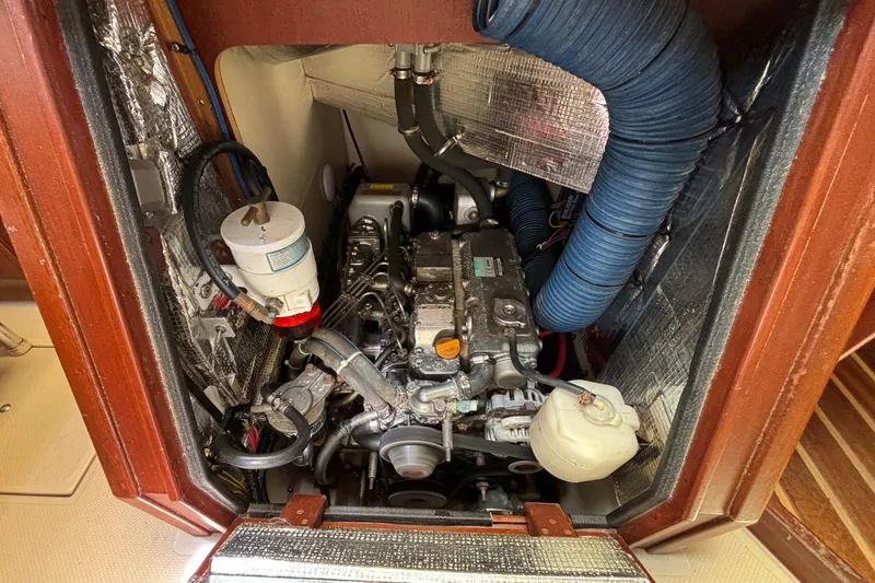 Slide: The Image of Engine compartment of a 2015 Island Packet 370 sailboat, showcasing mechanical components. - 44