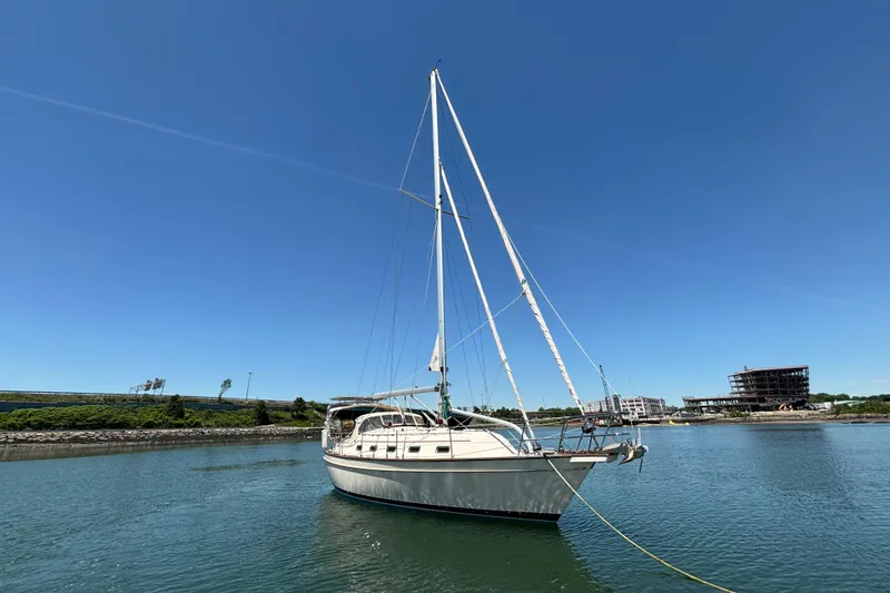 Slide: The Image of Sailboat Island Packet 370, 2015 model, anchored in calm waters under clear blue sky. - 6