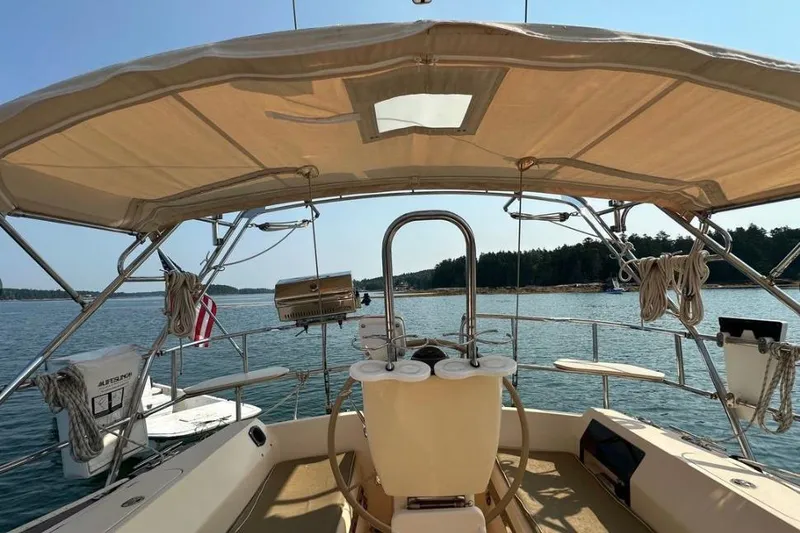 Slide: The Image of Cockpit view of 2015 Island Packet 370 sailboat on calm water. - 9
