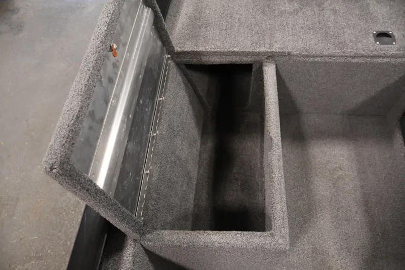 Slide: The Image of 2024 Tracker Pro 170 storage compartment with open lid, showcasing interior space. - 18