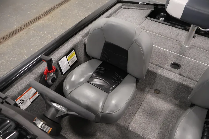 Slide: The Image of 2024 Tracker Pro 170 boat interior with gray seating and steering wheel. - 28