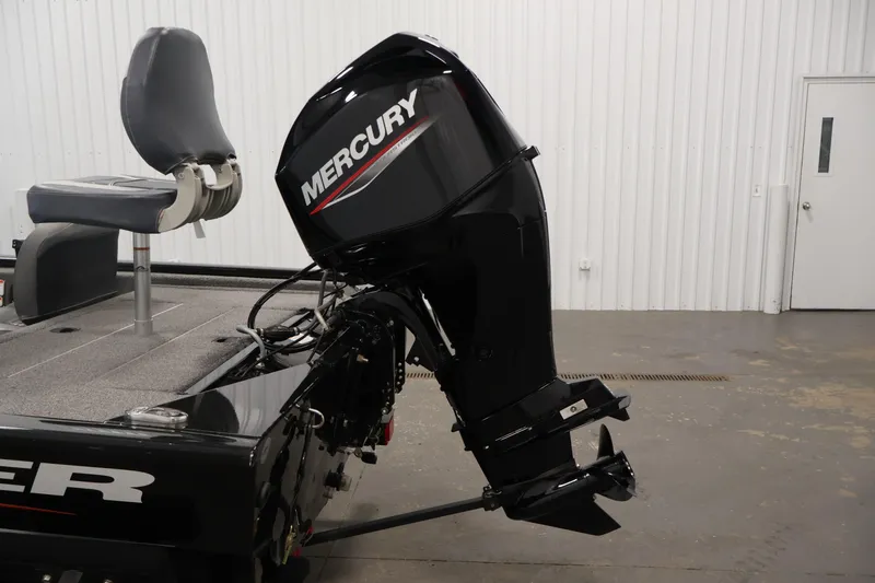 Slide: The Image of 2024 Tracker Pro 170 boat with Mercury outboard motor in a garage setting. - 33
