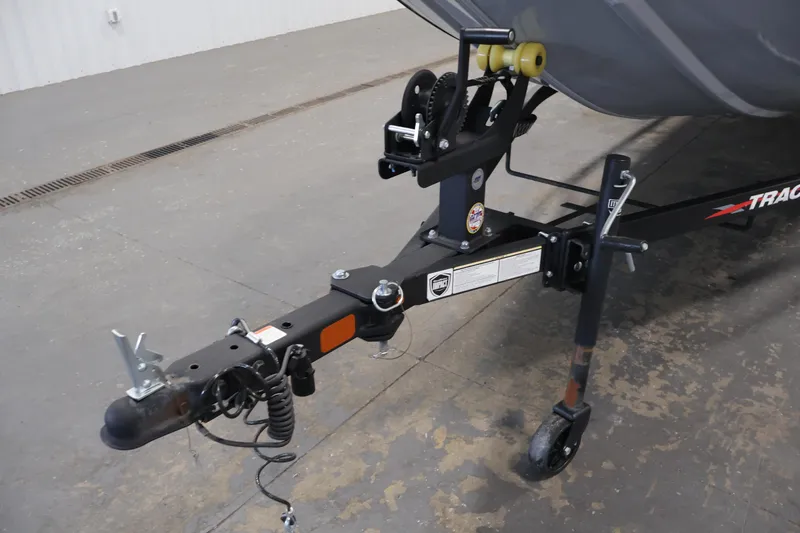 Slide: The Image of 2024 Tracker Pro 170 boat trailer hitch and winch system in a garage setting. - 37