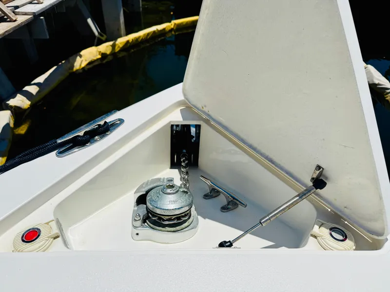 Slide: The Image of Anchor compartment of a 2003 Intrepid 377 boat, open with visible chain and winch. - 10