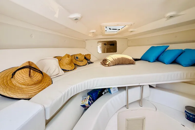 Slide: The Image of Interior cabin of a 2003 Intrepid 377 boat with hats and blue cushions. - 100