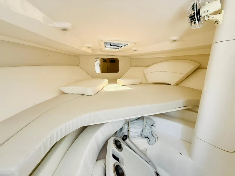 Slide: The Image of 2003 Intrepid 377 cabin interior with white cushioned seating and storage compartments. - 103
