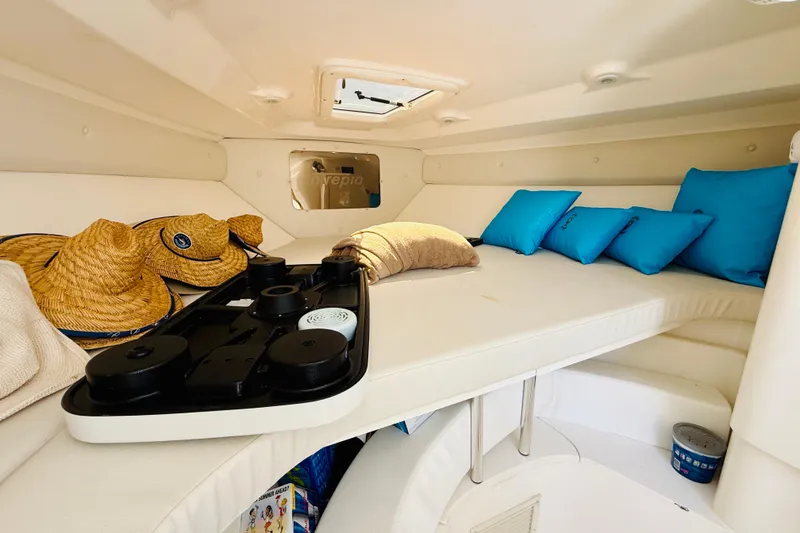 Slide: The Image of Interior cabin of a 2003 Intrepid 377 boat with cushions and hats. - 104