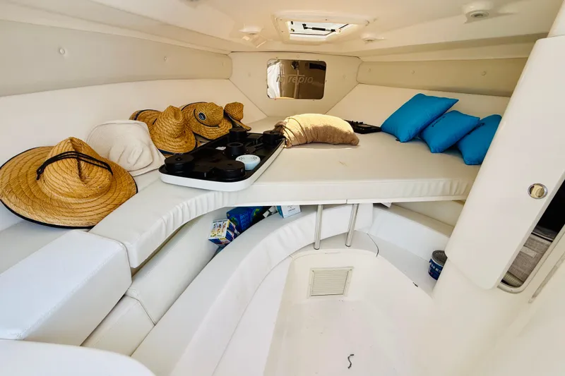 Slide: The Image of Cozy interior of a 2003 Intrepid 377 boat with hats and cushions. - 105