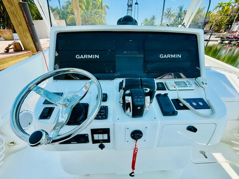 Slide: The Image of 2003 Intrepid 377 boat dashboard with Garmin navigation systems and steering wheel. - 29