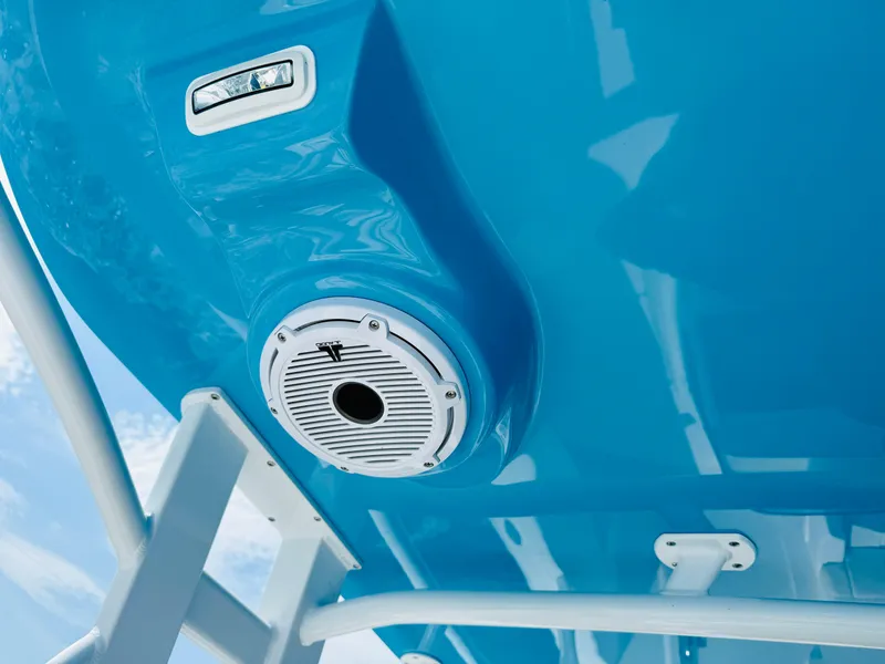 Slide: The Image of Close-up of a 2003 Intrepid 377 boat's blue hull with a speaker and light. - 33