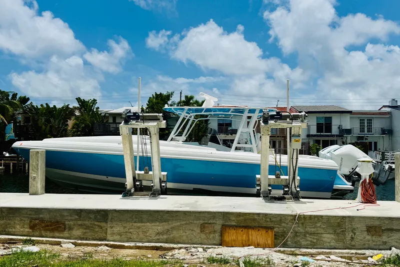 Slide: The Image of 2003 Intrepid 377 boat docked under a clear blue sky. - 46