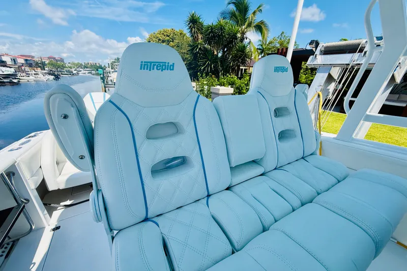 Slide: The Image of Luxurious seating on a 2003 Intrepid 377 boat, featuring plush white upholstery. - 56