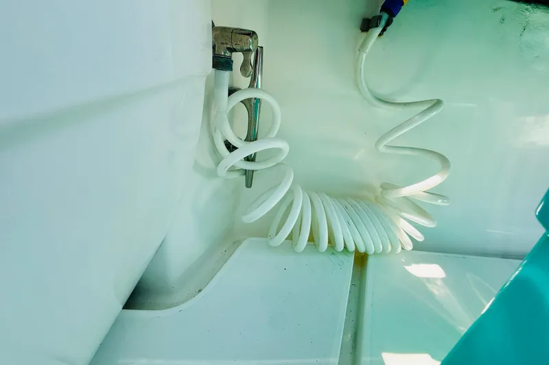 Slide: The Image of Coiled hose in 2003 Intrepid 377 boat interior, showcasing marine equipment details. - 69