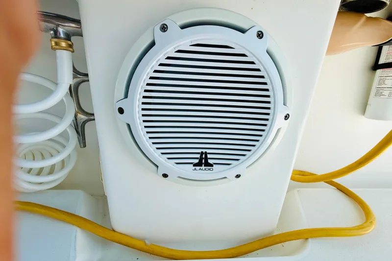 Slide: The Image of JL Audio speaker on a 2003 Intrepid 377 boat, surrounded by coiled hoses. - 70