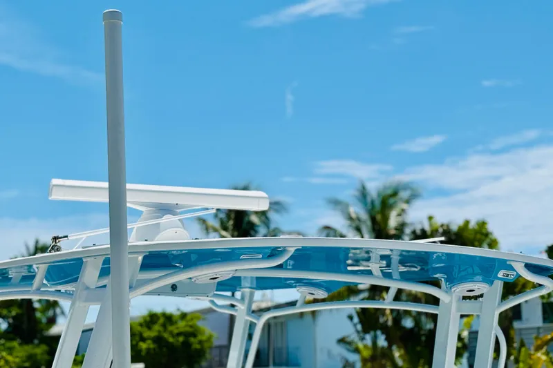 Slide: The Image of T-top of a 2003 Intrepid 377 boat against a clear blue sky. - 72