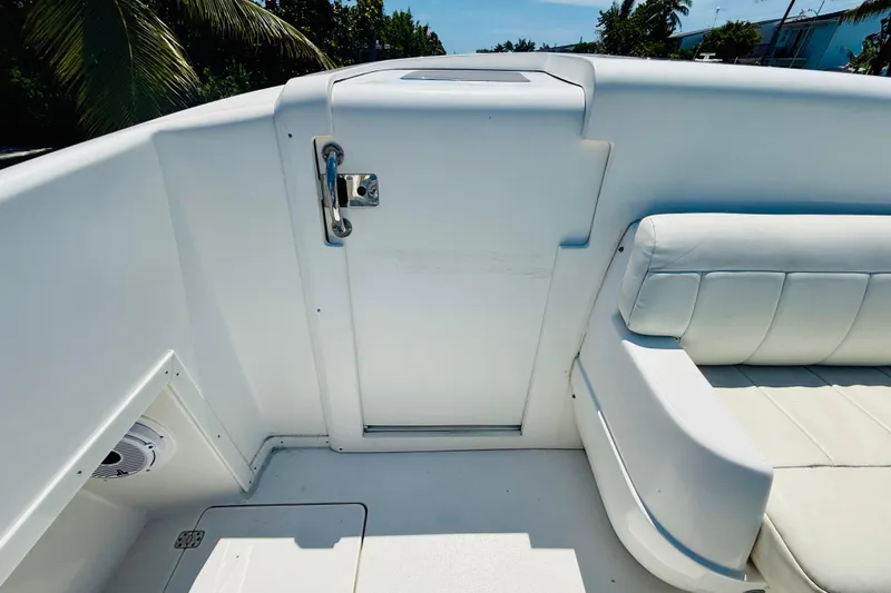 Slide: The Image of 2003 Intrepid 377 boat interior with white seating and secure door latch. - 76