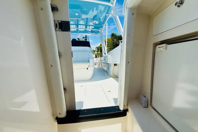 Slide: The Image of Interior view of a 2003 Intrepid 377 boat, showcasing seating and storage. - 84