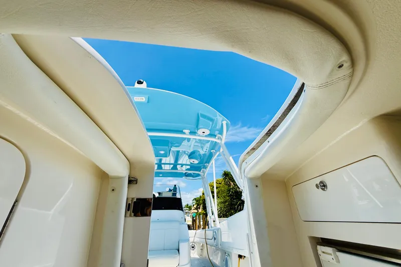 Slide: The Image of 2003 Intrepid 377 boat interior with blue sky and sleek design elements. - 85