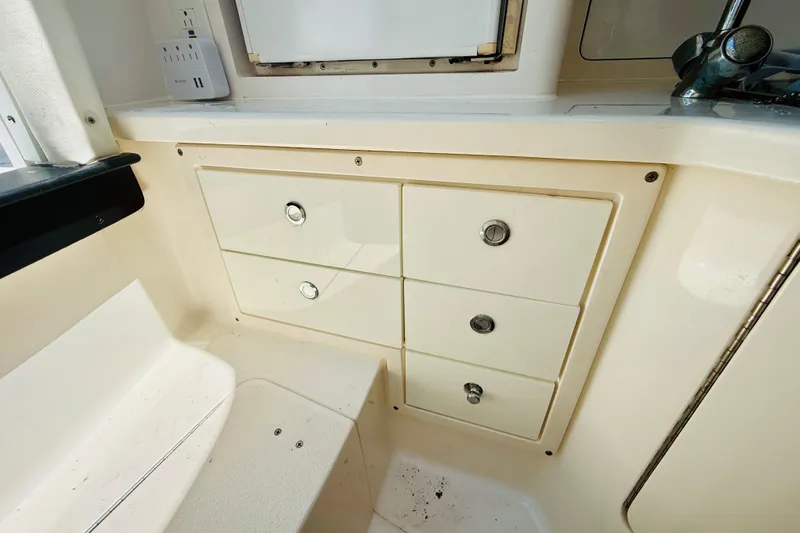 Slide: The Image of Interior view of a 2003 Intrepid 377 boat featuring storage drawers. - 86