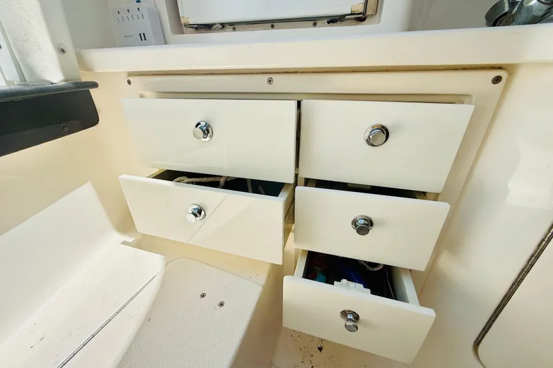 Slide: The Image of Open storage drawers on a 2003 Intrepid 377 boat, showcasing interior organization. - 87