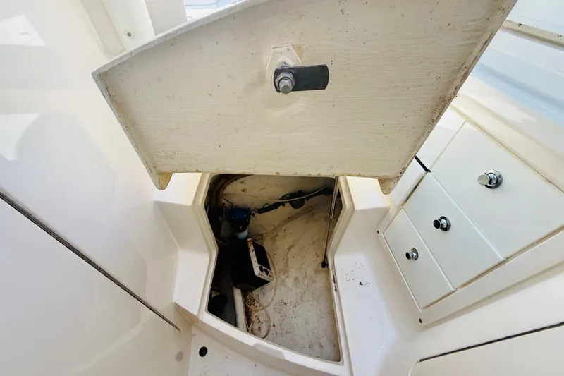 Slide: The Image of Open storage compartment on a 2003 Intrepid 377 boat, showing interior details. - 88