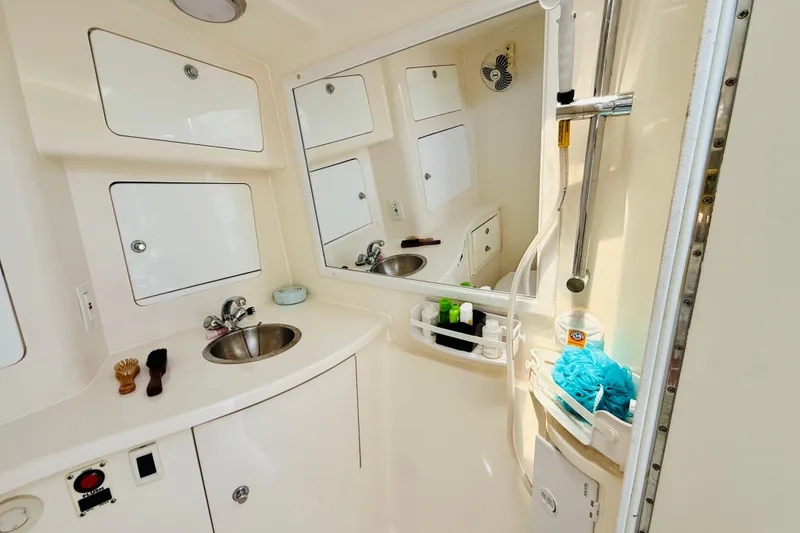 Slide: The Image of Bathroom interior of a 2003 Intrepid 377 boat, featuring sink and shower amenities. - 93