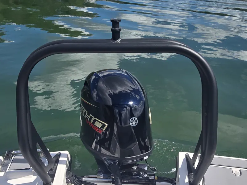Slide: The Image of An outboard motor on a boat in calm water, surrounded by a sturdy black frame. - 6