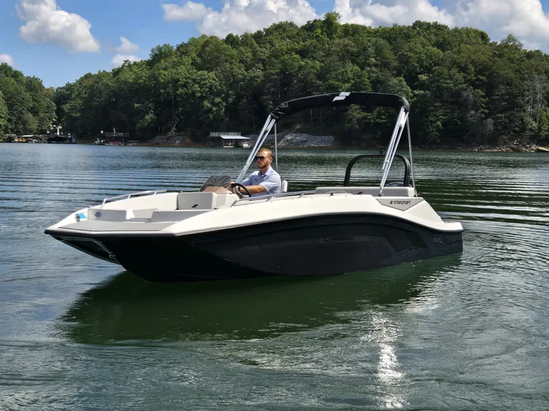 Slide: The Image of A modern 2027 Starcraft 181SVOB cruising on a calm lake, surrounded by trees. - 1