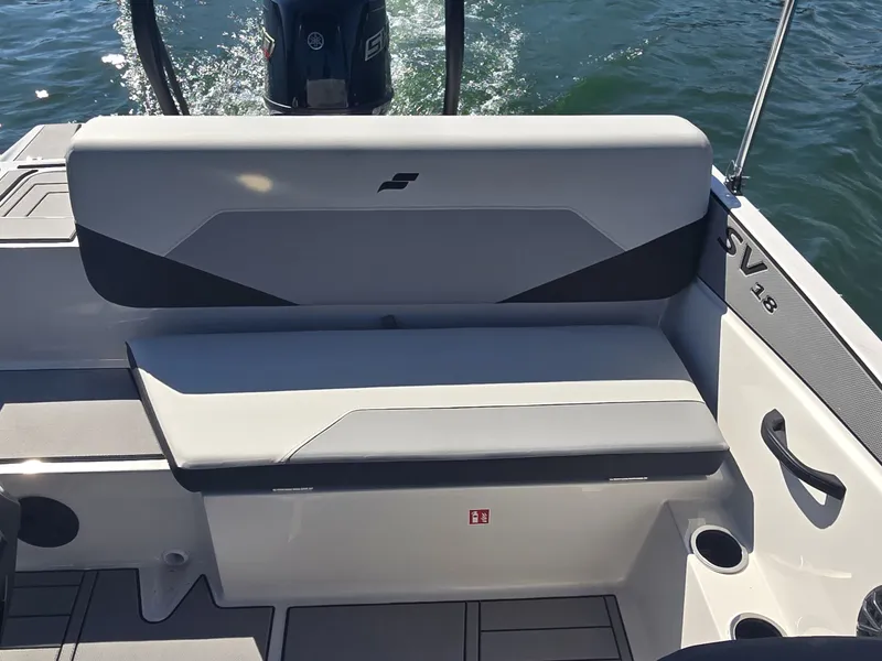 Slide: The Image of The 2027 Starcraft 181SVOB features a cushioned bench seat with cup holders on a boat. - 9
